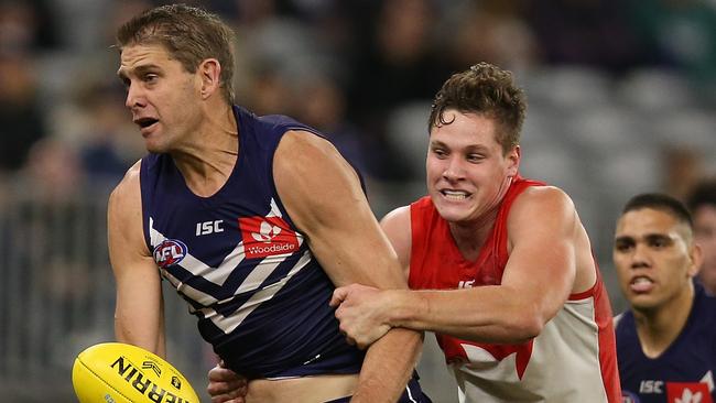 Hayden McLean tackles Aaron Sandilands during his AFL debut for Sydney. Picture: Paul Kane/Getty Images.