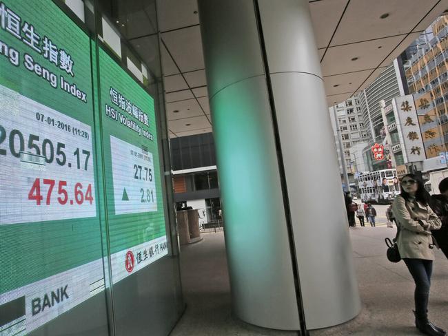 Nervous watch ... China’s trading halt sent share markets, Asian currencies and oil prices lower as investor jitters rippled across the globe. Picture: AP/Vincent Yu