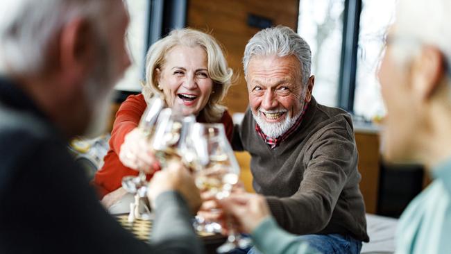 SENIOR/PENSIONER/MATURE/ELDERLY/OVER 65/GRANDPARENT/RETIREE/SUPERANNUATION. Picture: istock Happy mature couple toasting with their friends during social gathering at home.