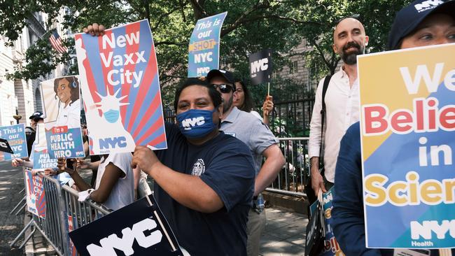 People cheer as hundreds of first responder workers and essential workers participate in a parade for the workers who helped navigate New York through Covid-19. Picture: AFP