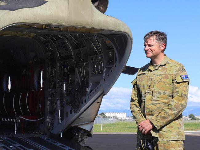 Former Australian Army technician avionics and current Boeing aircrewman aechnician instructor, Greg Maiden (left) from the School of Army Aviation is congratulated by the Commanding Officer of the 5th Aviation Regiment, Lieutenant Colonel Christopher McDougall, after completing 5000 hours of flying in the CH-47 Chinook at RAAF Base Townsville, Queensland. Photo: TPR Lisa Sherman