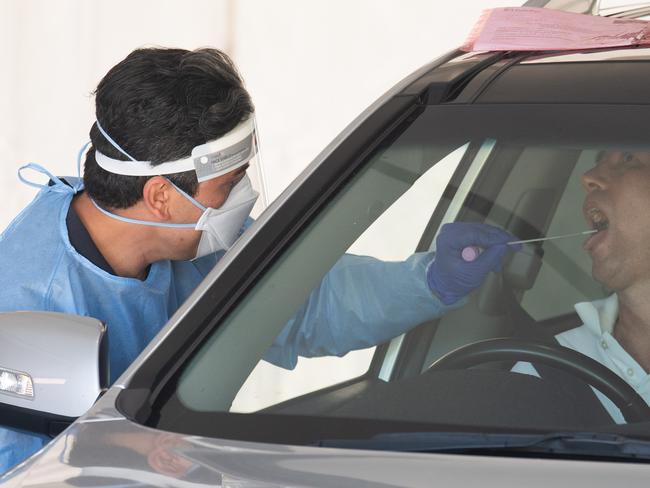 BRISBANE, AUSTRALIA - NewsWire Photos - OCTOBER 5, 2021.A health worker swabs a member of the public at a drive through Covid-19 clinic in Brisbane. Picture: NCA NewsWire / Dan Peled