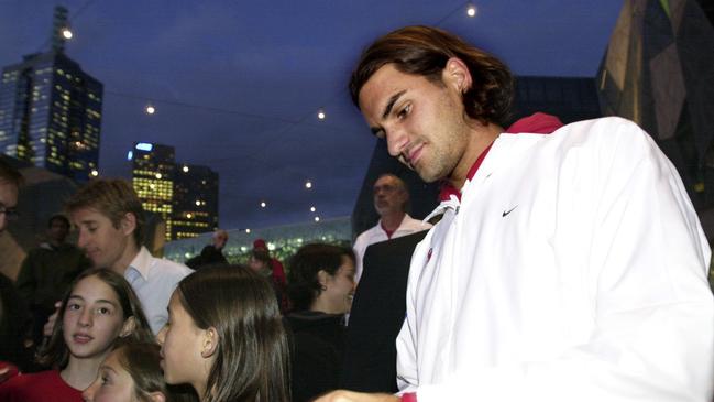 Roger Federer signs autographs at Federation Square before the Davis Cup semi-final tie against Australia in 2003. Picture: AAP