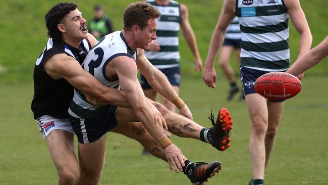 VAFA: Jacob Jess of Old Geelong is tackled by Andrew Kovac of Mazenod. Photo: Hamish Blair