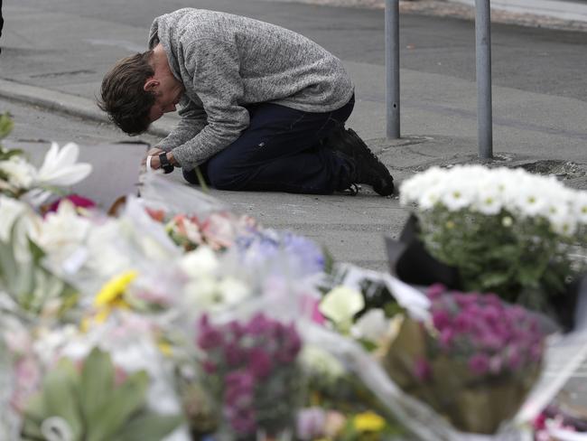 A mourner prays near the Linwood mosque. Picture: Mark Baker/AP