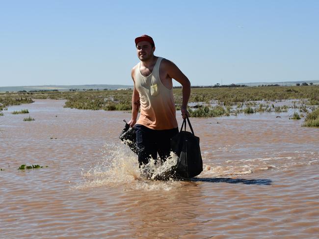 Port Wakefield resident Michael Brown had to wade back home through the flood from his job at a local chicken farm. Picture: Campbell Brodie.