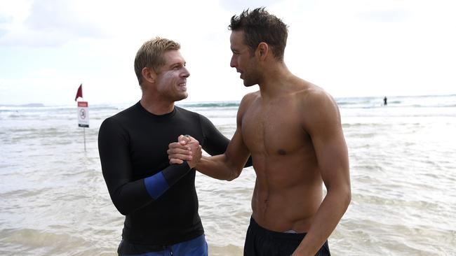 Mick Fanning giving South African swimmer Chad Le Clos a surf lesson.