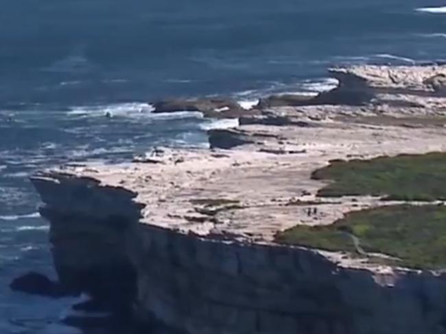 **MUST CREDIT 7NEWS** Vison of rescue attempt April 17, 2020. The body of a man missing in Kurnell after being swept off rocks yesterday has been found. About 10.20am today (Saturday 18 April 2020), Police Marine Area Command, assisted by Surf Rescue, Marine Recue and Pol Air, located the body of a 67-year-old man on the rocks at Potter Point. He is the second man to die in the incident, after emergency services responded to reports that two rock-fishermen were in difficulty after falling into the water just after 12.30pm yesterday (Friday 17 April 2020). Another man, also aged 67, was located and retrieved from the water on Friday, but died at the scene at 1.35pm. Picture: 7NEWS