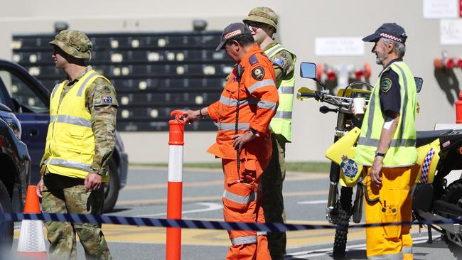 ADF personnel with police and the SES at the Queensland border. Picture: NIGEL HALLETT