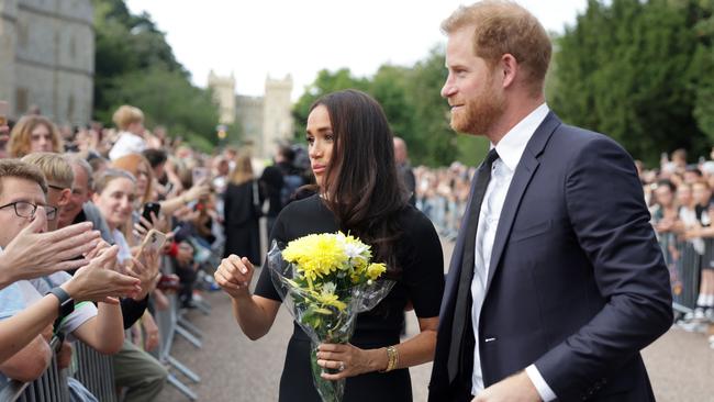 Meghan Duchess of Sussex and Prince Harry, Duke of Sussex speak with wellwishers at Windsor Castle following Queen Elizabeth II’s death. Picture: Getty Images