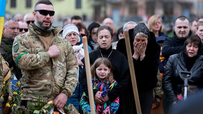 Christina Dragun holds her daughter Olya Siksoy during the burial for her husband Ukrainian soldier Ruslan Siksoy in Lviv. Siksoy was killed while fighting against the Russian military in the Donbas area. Picture: Getty Images