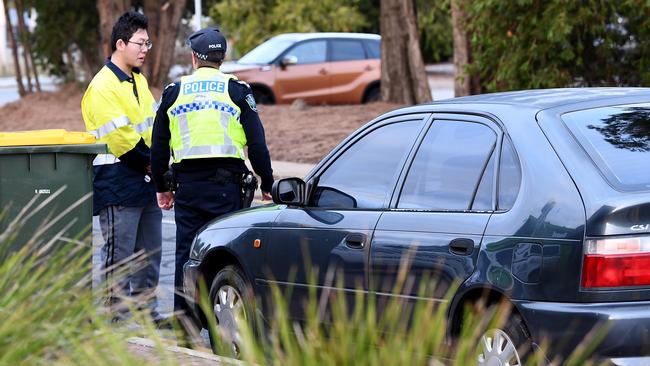 Driver on the car speaks with police after his car became stuck on the tracks. Picture: Mark Brake