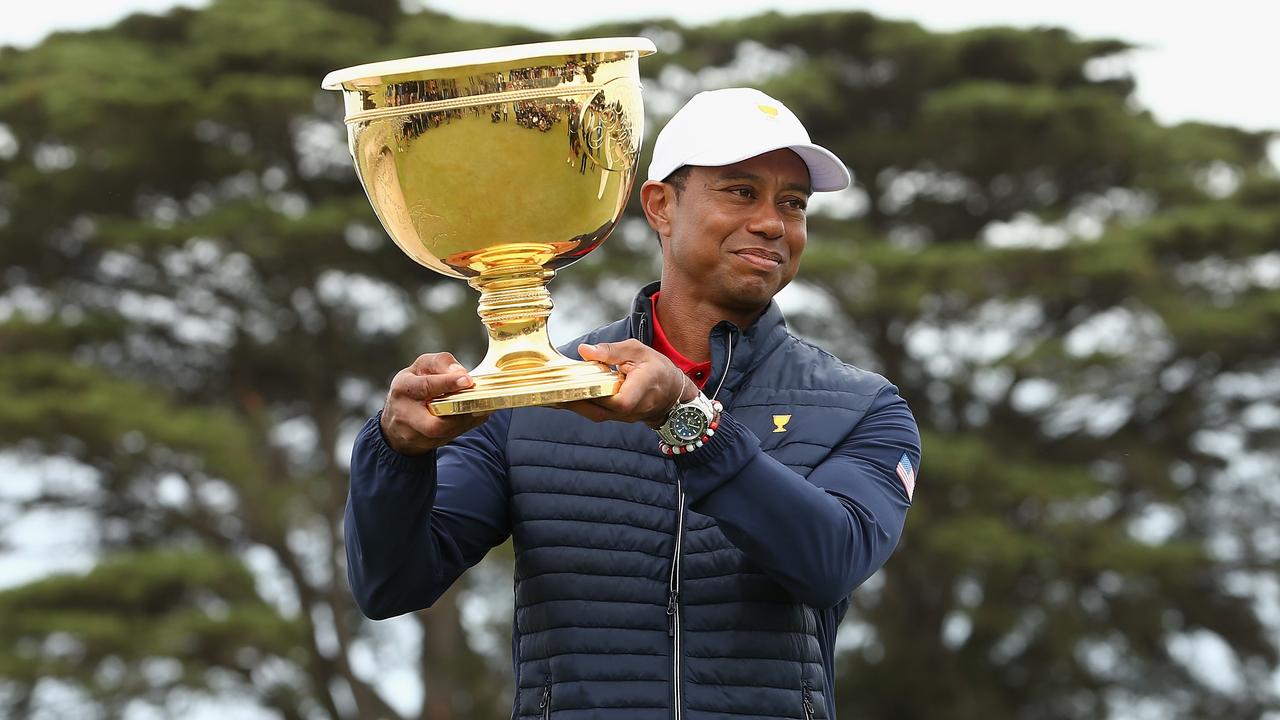 United States playing captain Tiger Woods lifts the Presidents Cup at Royal Melbourne in 2019. Picture: AAP / Rob Prezioso