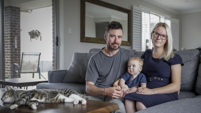 Jessica and Adam Hicks, with their son Oscar, 11 months, at home in Googong, NSW. Picture: Sean Davey.