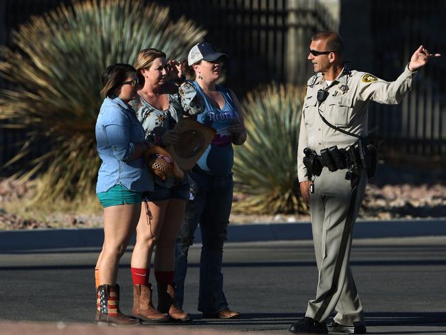 Police assist those caught up in the carnage. Picture: AFP