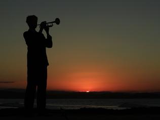 Lindisfarne year 10 student Monty Lush plays the Last Post as the sun sets over the Gold Coast on ANZAC day.Photo: Scott Powick Newscorp