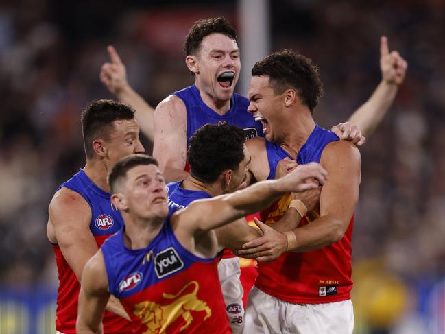 Cam Raynerand teammates celebrate a goal. Picture: Darrian Traynor/AFL Photos/via Getty Images.