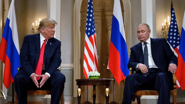 Vladimir Putin and Donald Trump are pictured before a meeting in Helsinki, July, 2018.