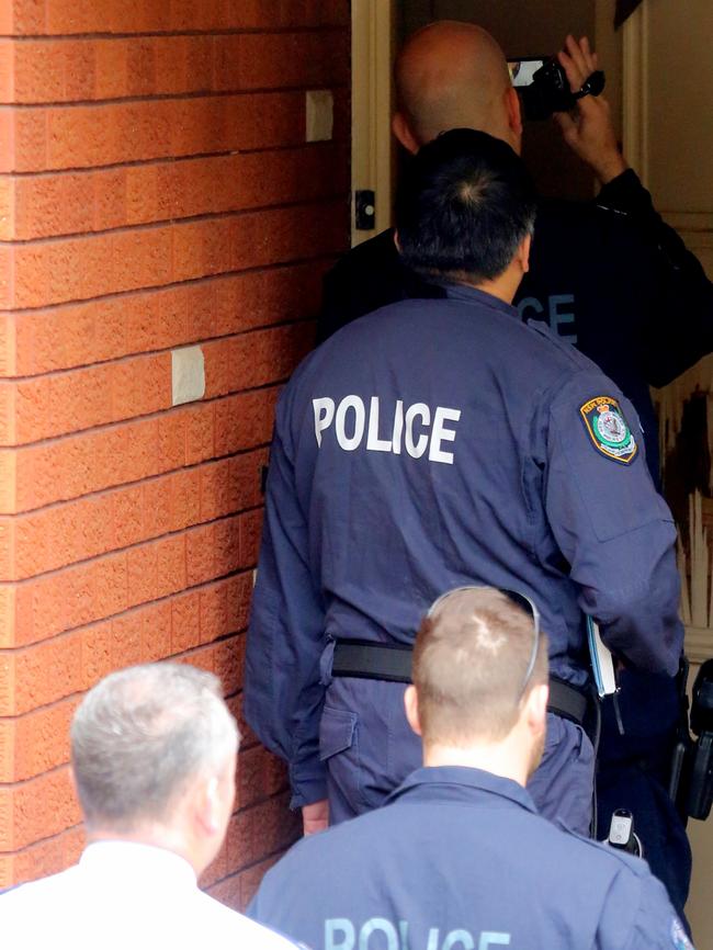 Police raid a house nearby. Picture: John Grainger