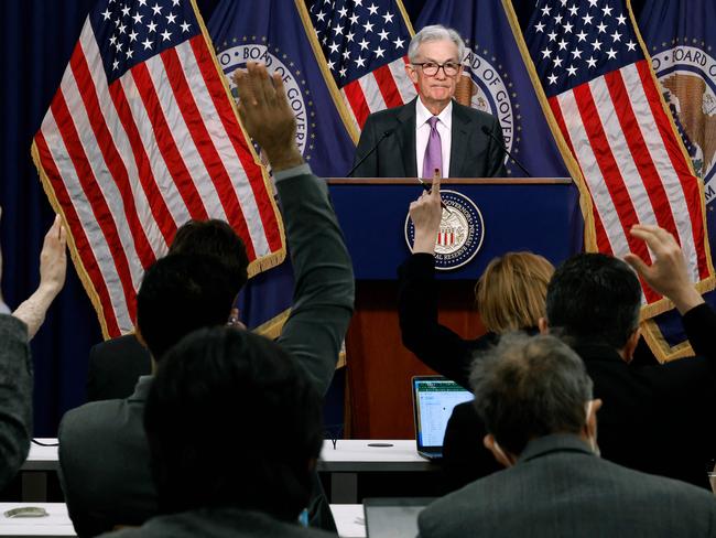 WASHINGTON, DC - MARCH 20: Reporters raise their hands to ask questions of Federal Reserve Bank Chair Jerome Powell during a news conference at the bank's William McChesney Martin building on March 20, 2024 in Washington, DC. Following a meeting of the Federal Open Markets Committee, Powell announced that the Fed left interest rates unchanged at about 5.3 percent, but suggested it may cut rates three times later this year as inflation eases.   Chip Somodevilla/Getty Images/AFP (Photo by CHIP SOMODEVILLA / GETTY IMAGES NORTH AMERICA / Getty Images via AFP)