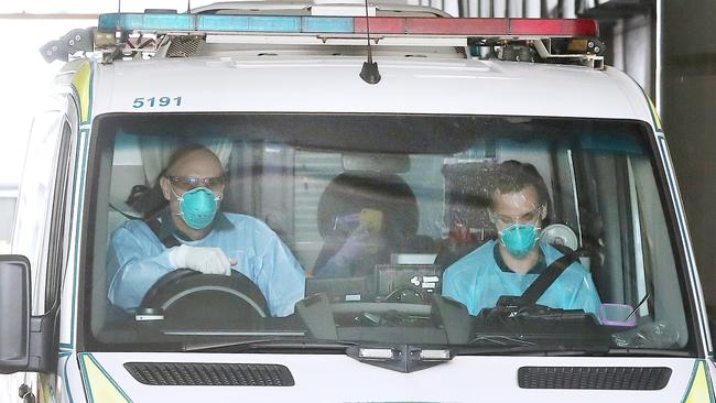 An ambulance ferries someone from the Hotel Grand Chancellor to another hotel quarantine. Picture: Tara Croser.