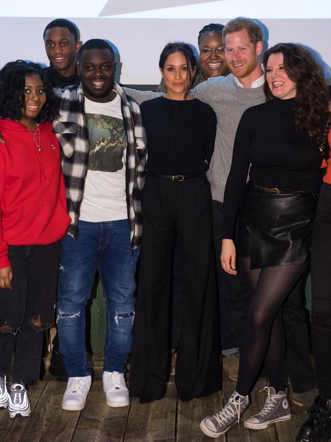 Britain’s Prince Harry (2nd R) and fiancée US actress Meghan Markle (C) pose for a photograph during a visit to Reprezent 107.3FM community radio station in Brixton, south west London on January 9, 2018. During their visit to the station, they met some of the presenters, content producers and staff, heard more about their training programmes, and met some of the current and former volunteers who have benefitted from the training. Picture: AFP