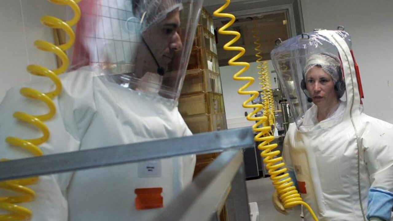 Researchers in a European lab preparing to receive the new swine flu influenza virus H1N1. in 2009. Picture: Laurent Cipriani