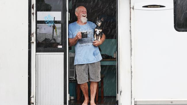 Retiree Barry Redgrave, with his dog Pipsqueak, was travelling from Mount Carbine to Airlie Beach when he was forced to camp at Tully due to the Bruce Highway being closed by flood water at Euramo. Picture: Brendan Radke