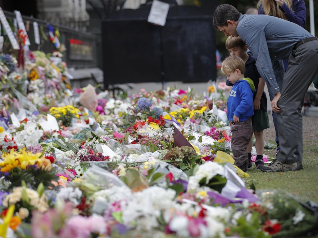 Mourners lay flowers on a wall at the Botanical Gardens in Christchurch, New Zealand. Picture: AP