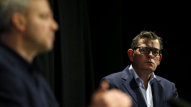 Daniel Andrews listens to Victoria's Chief Health Officer Professor Brett Sutton address the media in July 2020.