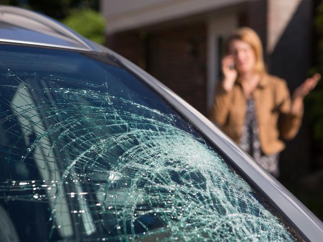 Woman Phoning For Help After Car Windshield Has Broken, car insurance generic windscreen cracked