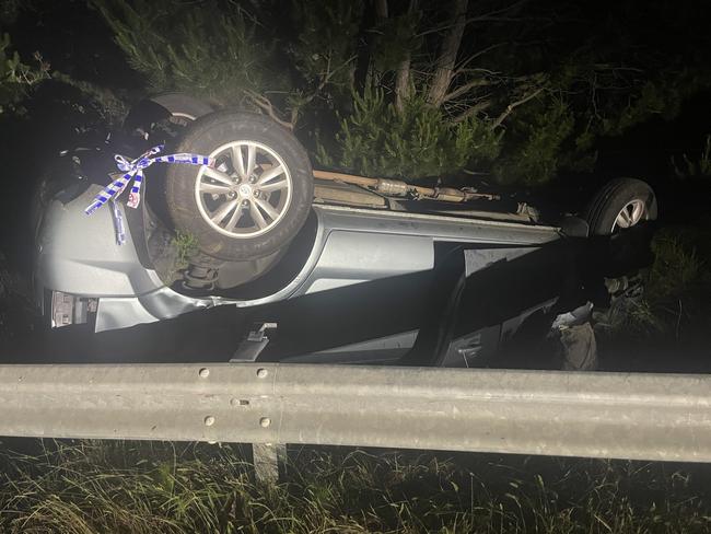 A driver has had a lucky escape after their car left the road, flipped and landed upside down behind the metal barrier on Tyers Rd in Traralgon just before 10pm on Wednesday. Picture: Jack Colantuono