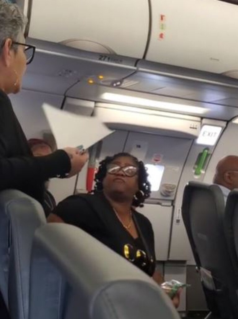 The woman on board the Frontier flight before being escorted.