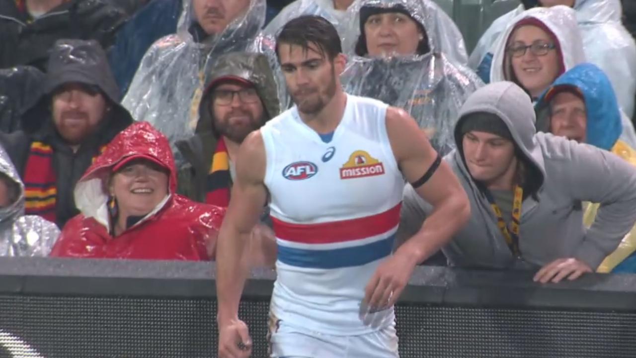 Crows fan touches Western Bulldogs captain Easton Wood at Adelaide Oval.
