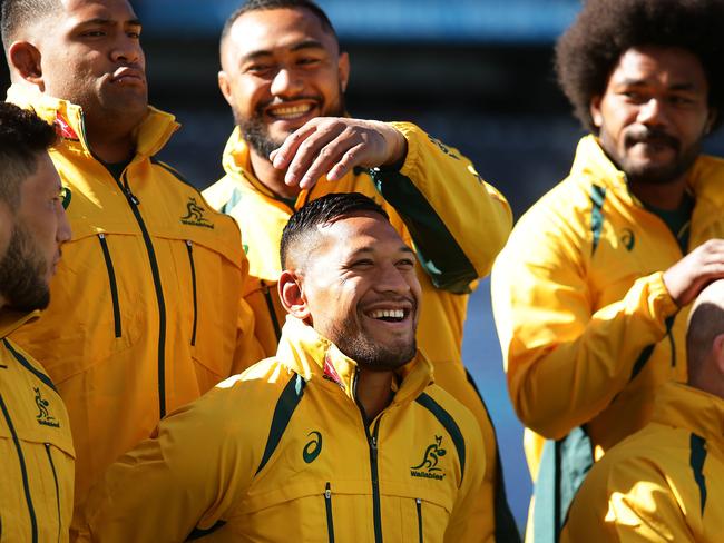 Israel Folau has his hair adjusted by Sekope Kepu during the Australian Wallabies team photo at ANZ Stadium, Homebush. Picture: Brett Costello