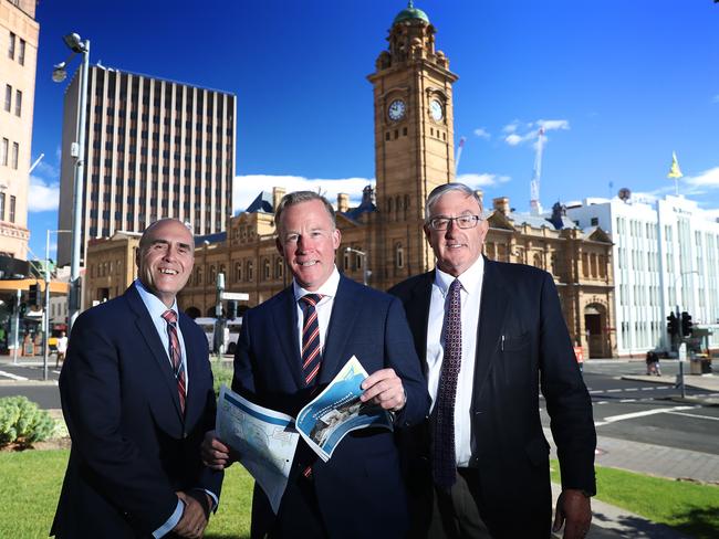 RACT CEO Harvey Lennon, left, Premier Will Hodgman and Transport Minister Rene Hidding discuss the Liberal's transport policy for the bus mall. Picture: LUKE BOWDEN