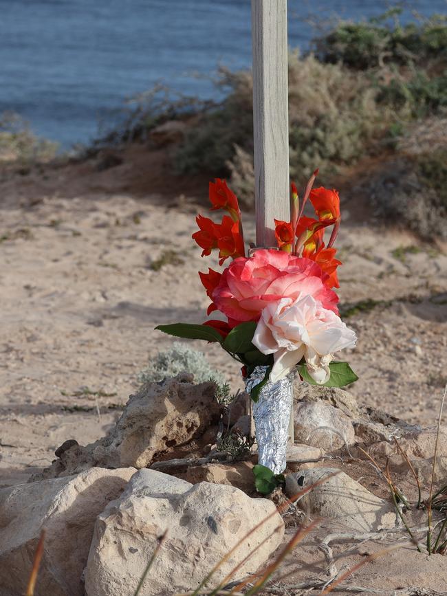 Flowers have been laid at the beach where Mr Baccanello was attacked. Picture: Riley Walter