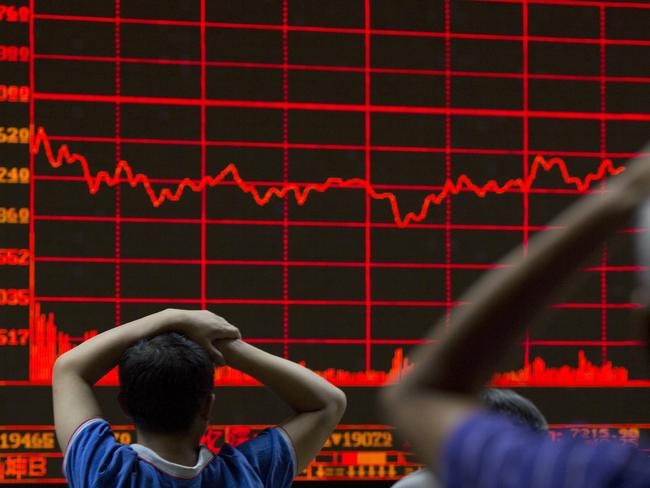 FILE - In this Monday, Aug. 31, 2015, file photo, investors monitor a display showing the Shanghai Composite Index at a brokerage in Beijing. From Australia to Zambia, Chile to Indonesia, the pain of China’s sharp economic slowdown is being felt in the form of depressed commodity prices, elevated unemployment and shrunken home prices. (AP Photo/Ng Han Guan, File)