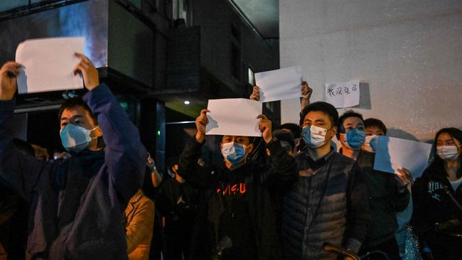 People show blank papers as a way to protest in Shanghai on November 27. Picture: by Hector RETAMAL / AFP