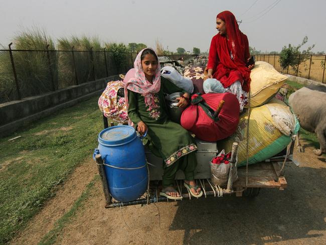 Villagers carry their belongings as they move to safer areas after authorities evacuated residents living near the border at Jeora Farm on the outskirts of Jammu. Picture: AFP