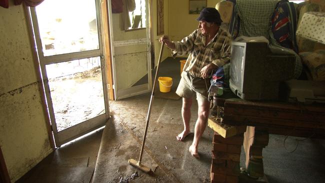 Fred Naylor leaning against the remains of his pool table, surveys the damage to his home at Kabra, south of Rockhampton. Picture: Lyndon Mechielsen