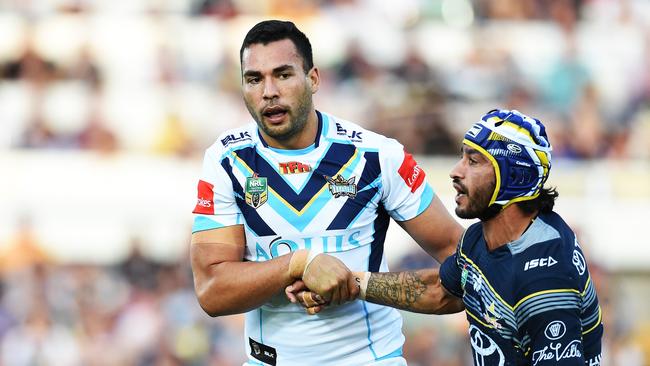 North Queensland Cowboys v Gold Coast Titans from 1300 Smiles Stadium, Townsville. Titans Ryan James helps Cowboys Johnathan Thurston up. Picture: Zak Simmonds