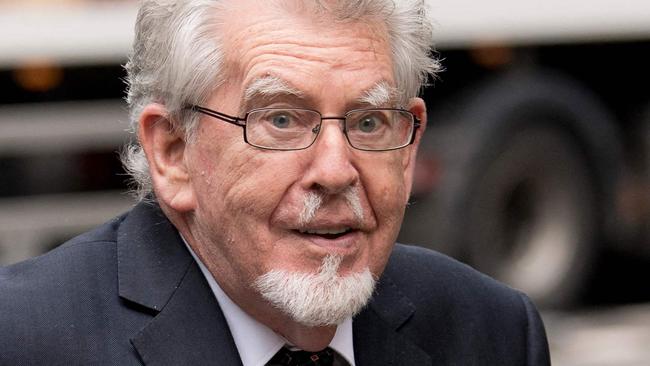 (FILES) Australian entertainer Rolf Harris arrives at Southwark Crown Court in London on May 22, 2017 for a court hearing accused of four counts of indecent assault. Artist, presenter and musician Rolf Harris, who was one of the UK's best-loved entertainers before he was convicted of underage-sex crimes in 2014, has died aged 93 and been buried, his family said on May 23, 2023. (Photo by Justin TALLIS / AFP)