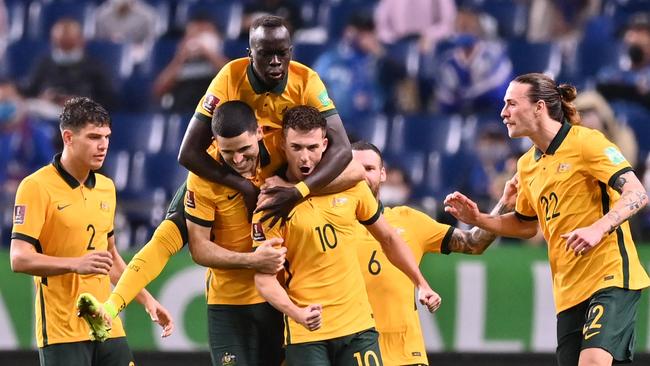 Australia's midfielder Ajdin Hrustic (C) celebrates after scoring a goal during the 2022 Qatar World Cup Asian Qualifiers group B football match between Japan and Australia, at Saitama Stadium in Saitama, on October 12, 2021. (Photo by CHARLY TRIBALLEAU / AFP)