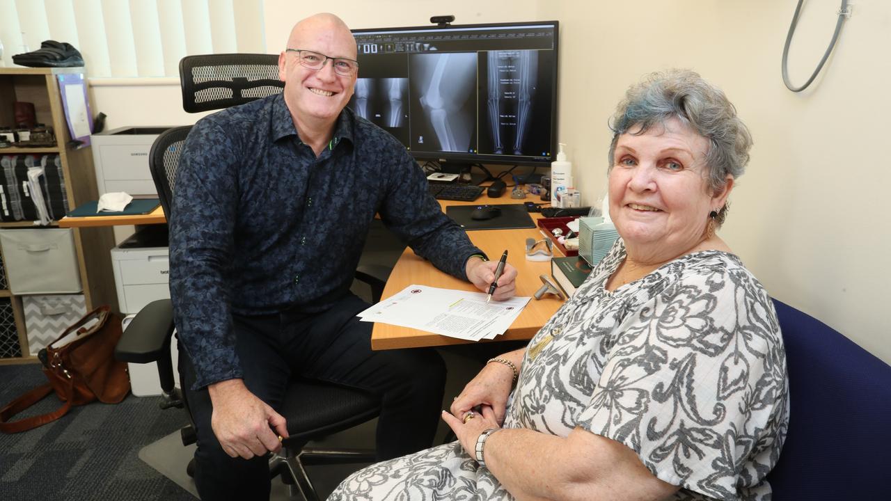 Mater orthopaedic surgeon Dr Chris Wainwright sits with patient Dale Redden. Picture: Mater