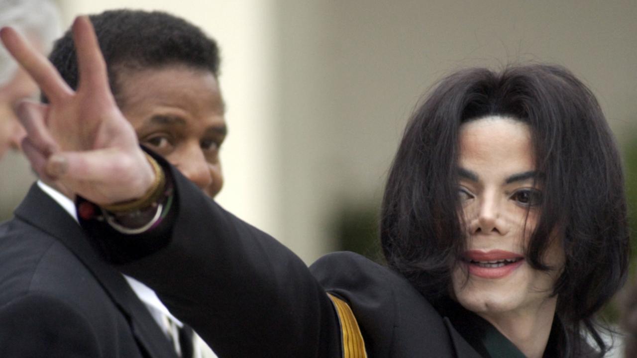 Jackson waves to his supporters during his 2005 trial. Picture: AP Photo/Michael A. Mariant, File