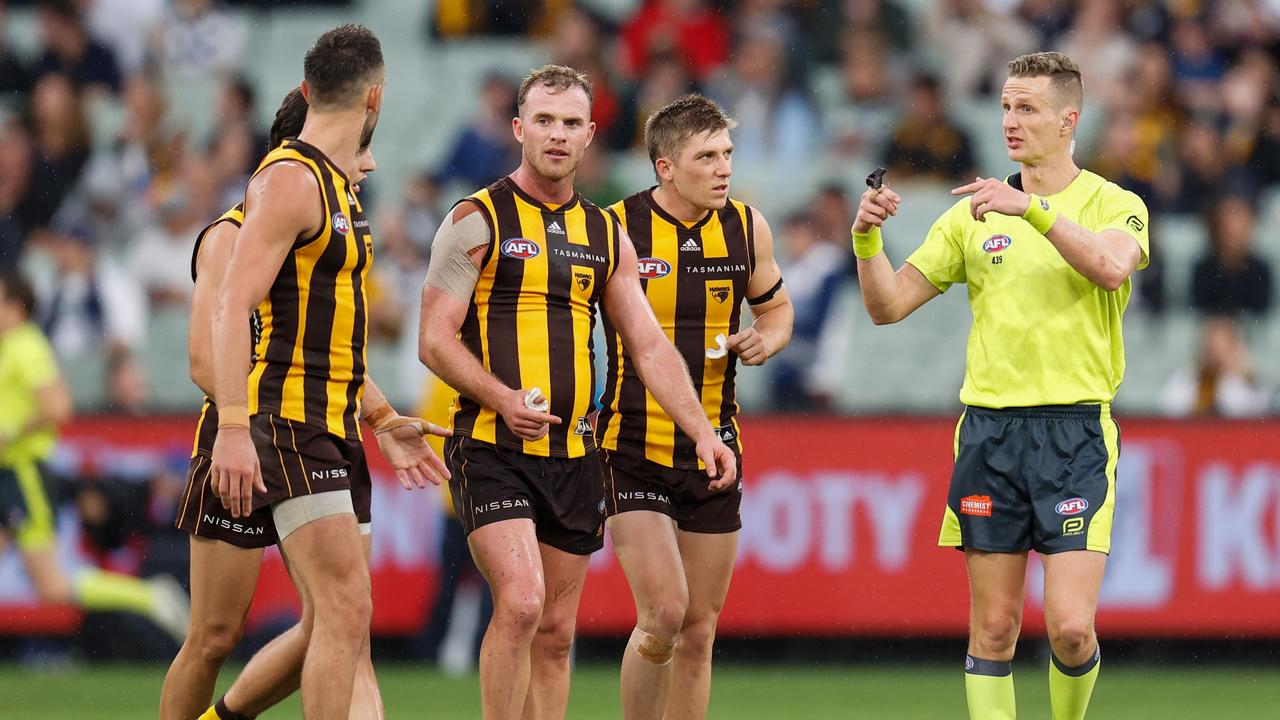 Tom Mitchell speaks with AFL Field Umpire, Hayden Gavine. Photo by Michael Willson/AFL Photos via Getty Images.