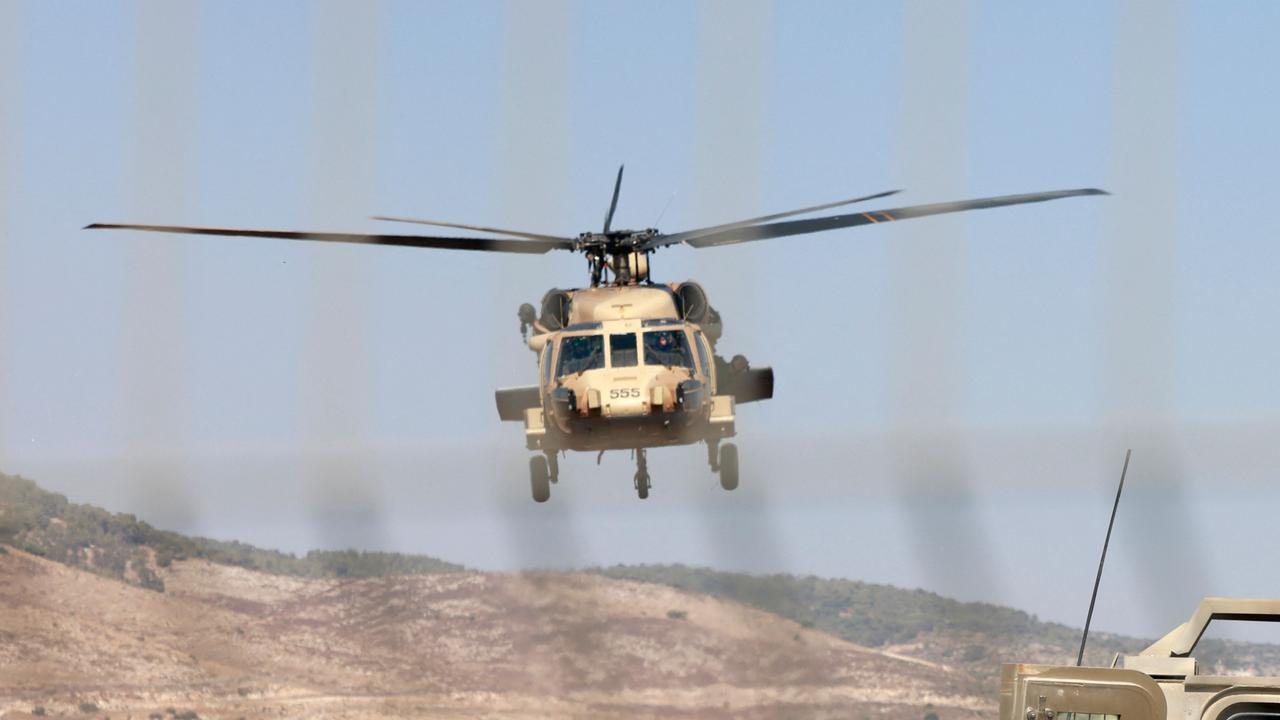 Israeli forces evacuate a wounded soldier in a Black Hawk helicopter in the Israeli town of Muqeibila, north of the occupied West Bank, on July 3, 2023. (Photo by Menahem KAHANA / AFP)