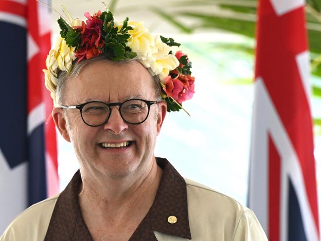 Australian Prime Minister Anthony Albanese wears a floral head piece while signing agreements with Prime Minister of Tuvalu Feleti Teo for the Australia-Tuvalu Falepili Union to come into force at the 53rd Pacific Islands Forum Leaders Meeting in Nuku'alofa, Tonga, Wednesday, August 28, 2024. Leaders from Pacific Island nations are gathering in Tonga for the 53rd Pacific Islands Forum Leaders Meeting. (AAP Image/Lukas Coch) NO ARCHIVING