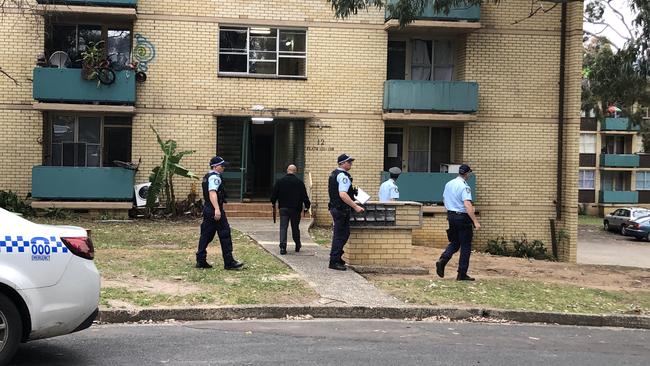 Police swarm the unit block on October 6. Picture: Madeline Crittenden